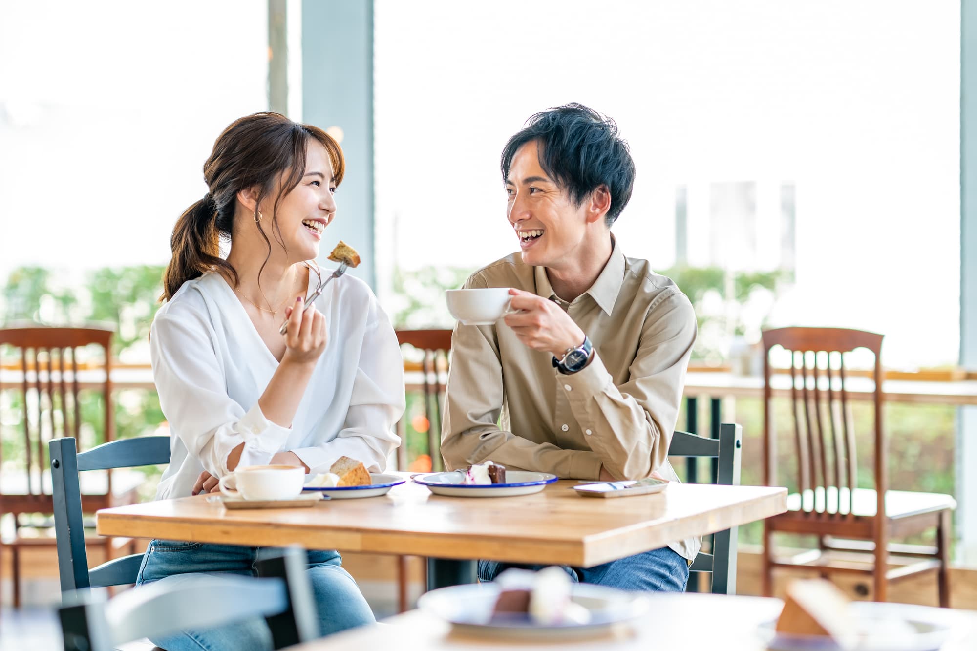 カフェで楽しそうに笑い合う男女